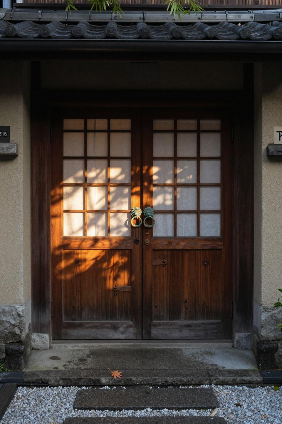 hinoki cypress double doors with hand-carved kumiko lattice panels and translucent washi paper in kyoto machiya townhouse
