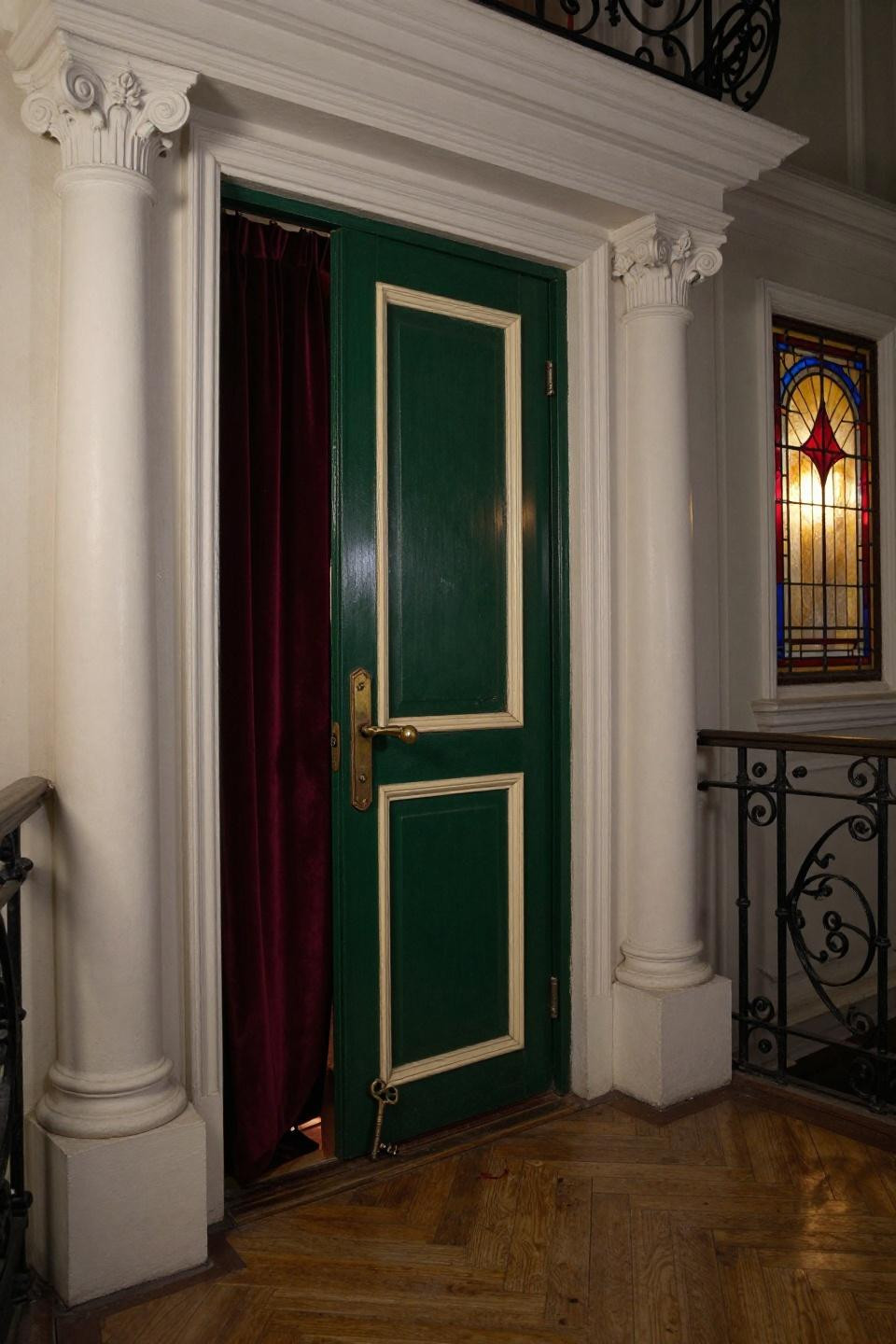 speakeasy bar design - emerald door with ruby stained glass