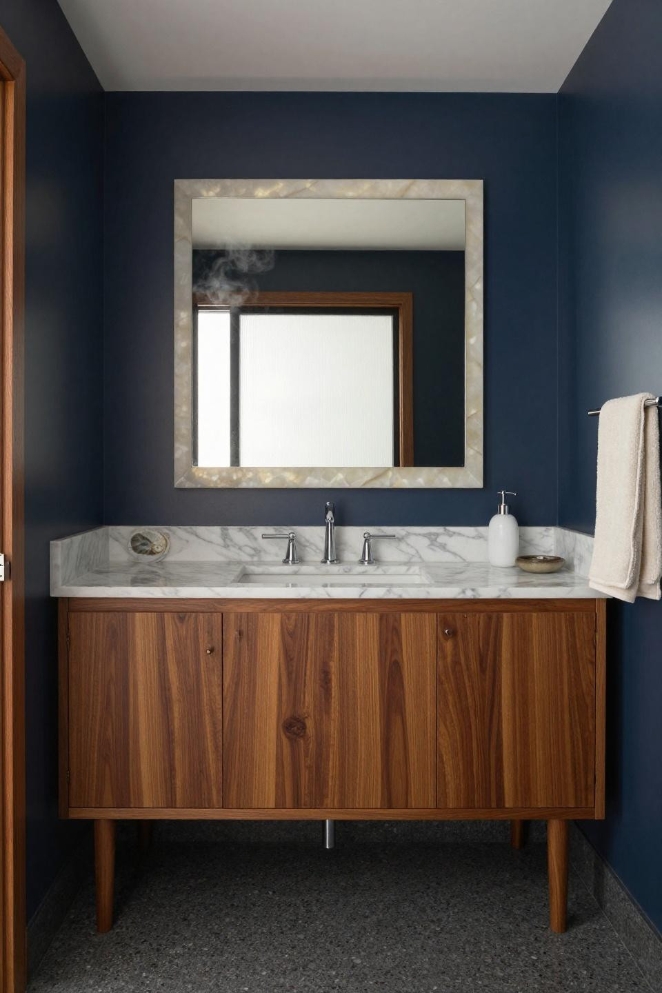 mid century modern bathroom teak vanity carrara marble countertop fossilized ammonite shells backlit onyx mirror chrome fixtures navy walls