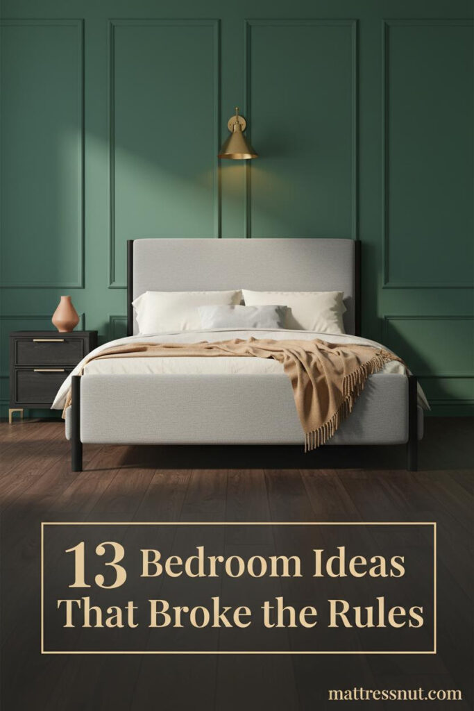 Black metal bed frame against deep forest green board-and-batten wall, dark walnut floors, cream linen bedding, brass sconce, camel throw