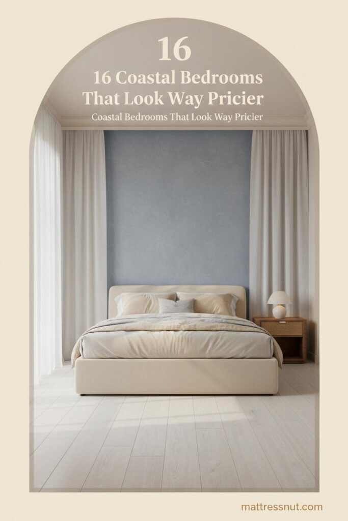 Coastal bedroom with dusty blue limewash wall, bleached oak floors, ivory linen bedding, rattan nightstand, and soft morning light through sheer panels