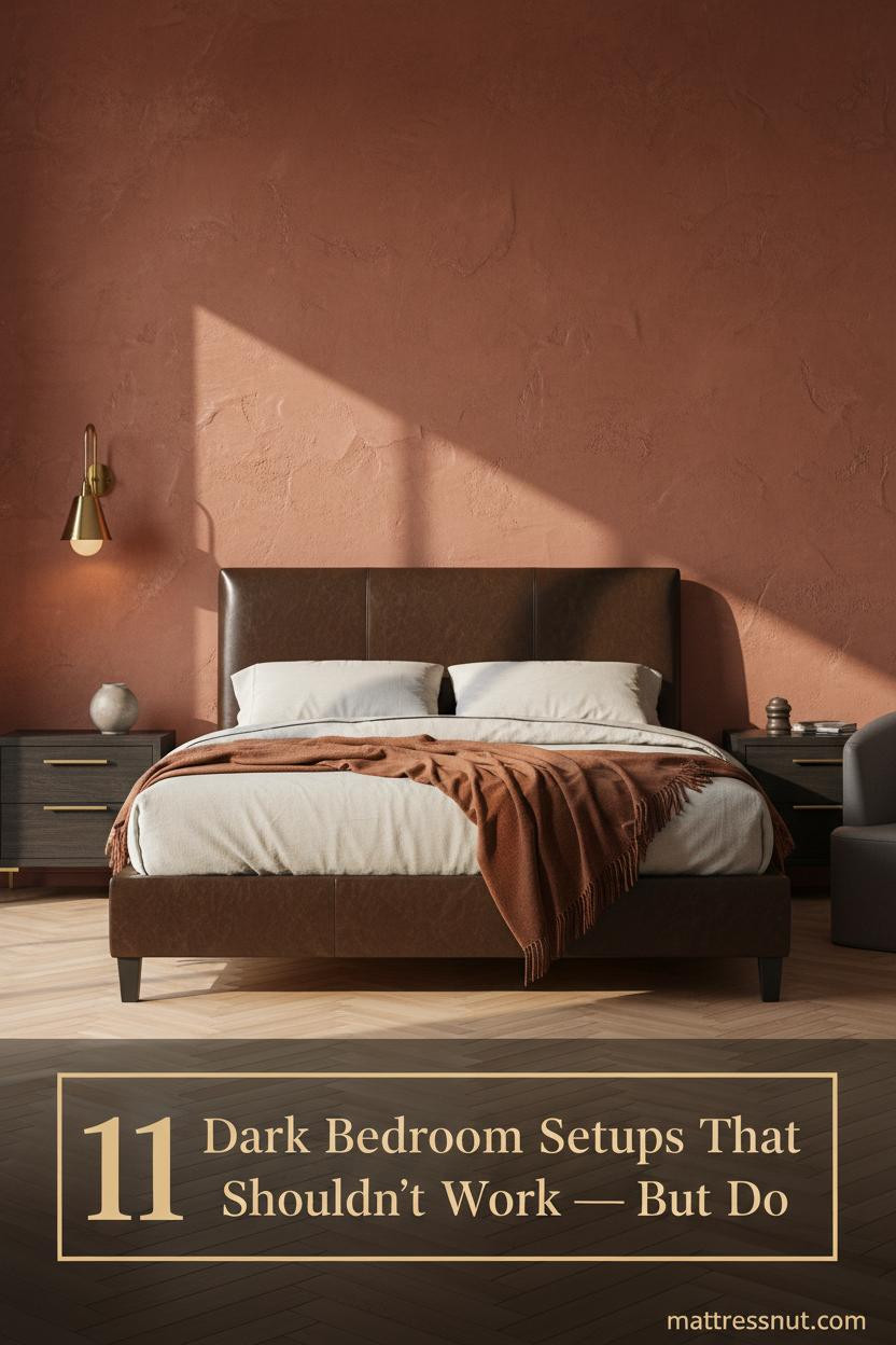 Dark grey bed frame bedroom with terracotta plaster wall, cream linen bedding, burnt sienna throw, brass sconce, and walnut nightstand