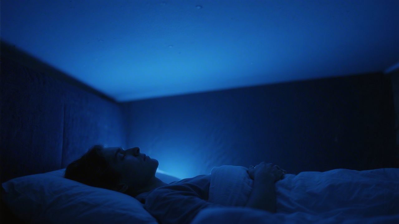 Person lying awake unable to sleep due to sleep disorder