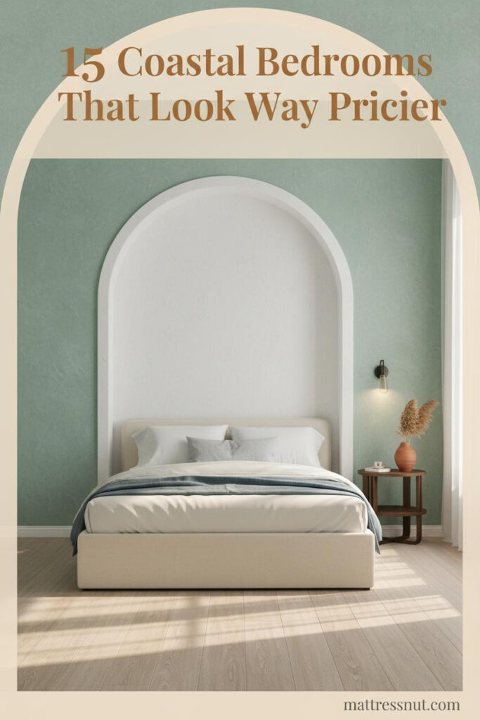 Coastal bedroom with seafoam limewash walls, whitewashed arch alcove, bleached oak floors, ivory bedding, slate-blue linen throw, and dried sea oats