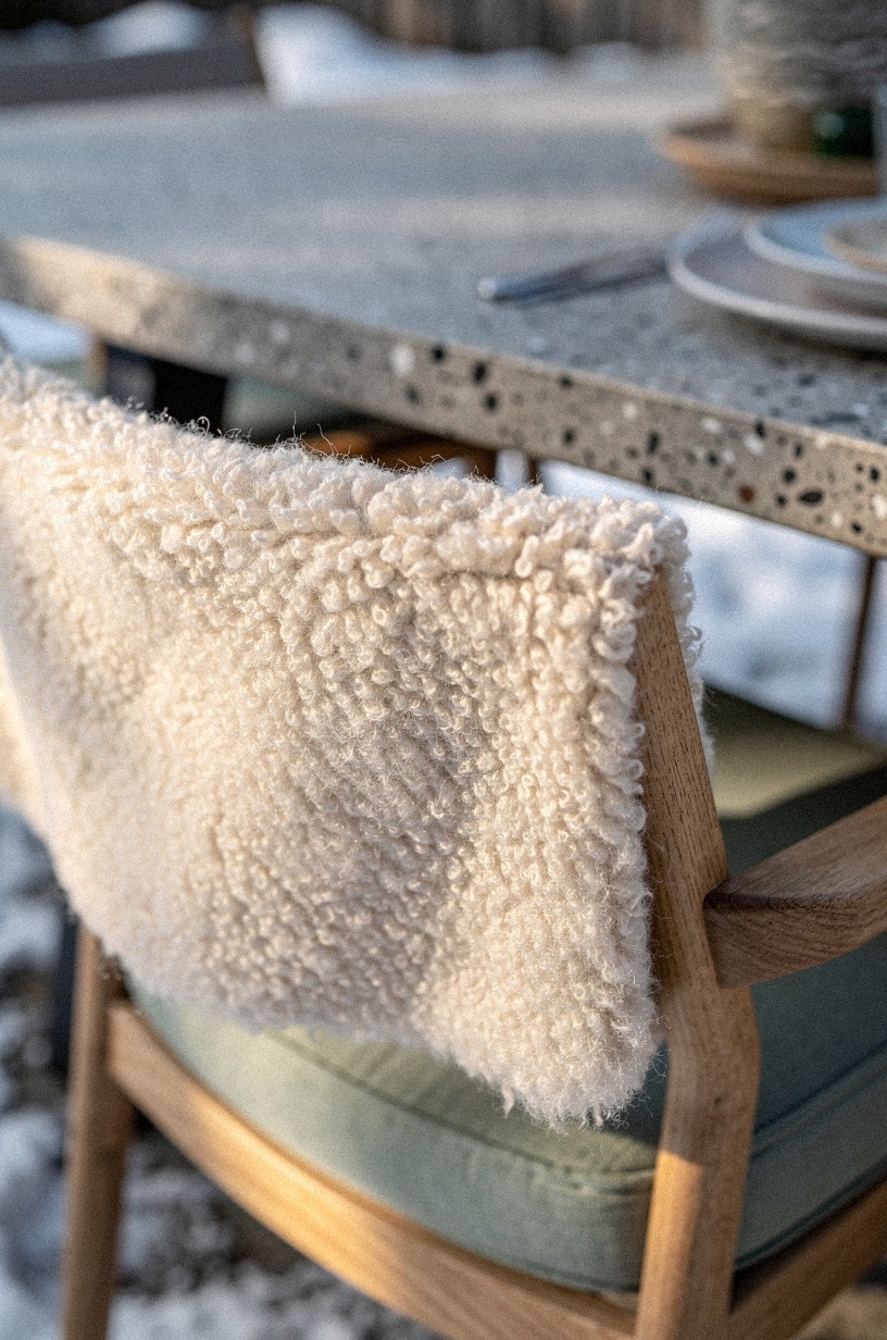 Add faux sheepskins to outdoor dining chairs
