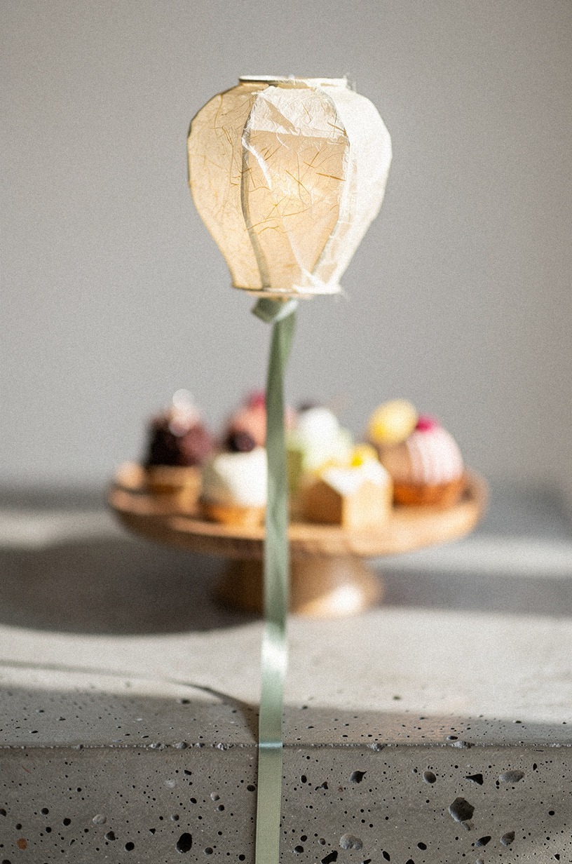Float paper lanterns above the dessert table