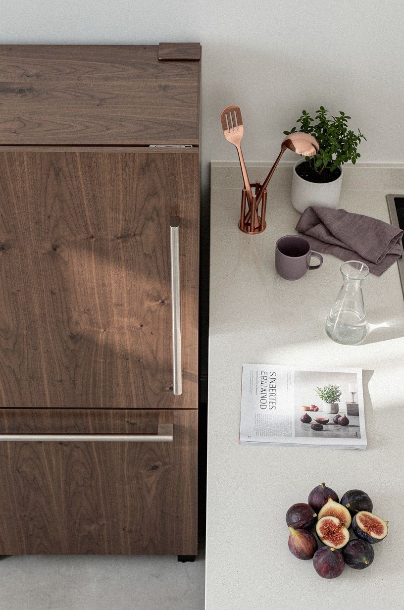 Wrap the fridge with matching cabinet panels