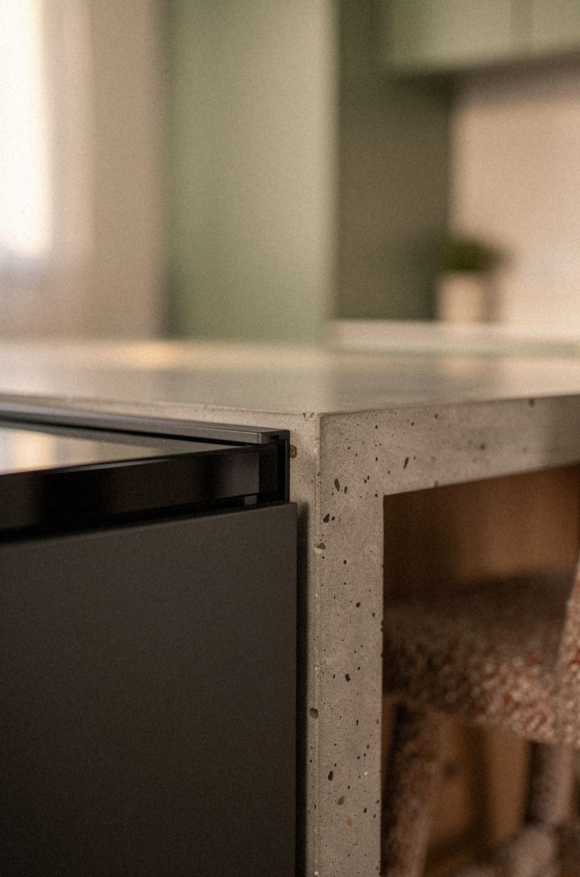Pair black glass with matte charcoal cabinetry