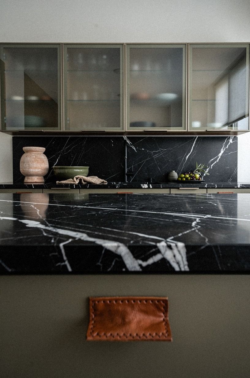 Float glass-front cabinets above the sink wall