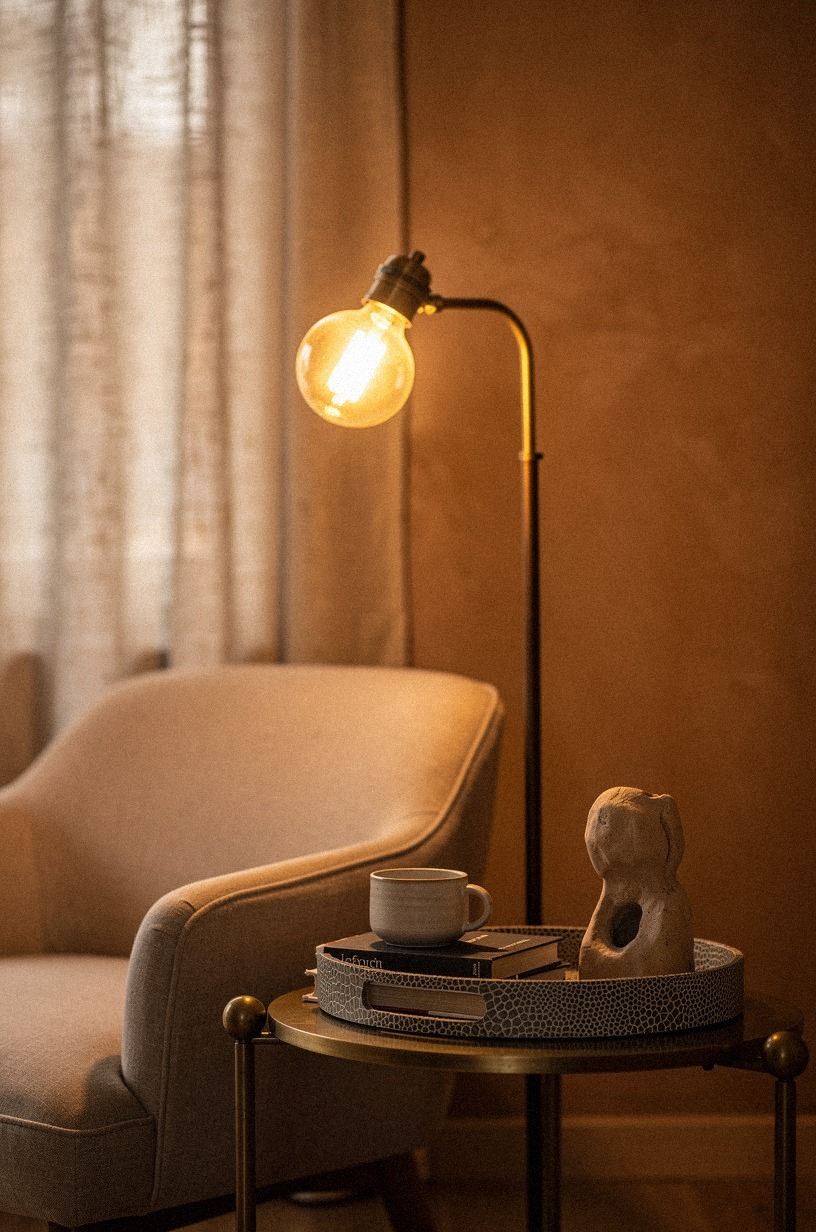 Angle a floor lamp with a warm bulb right behind the chair