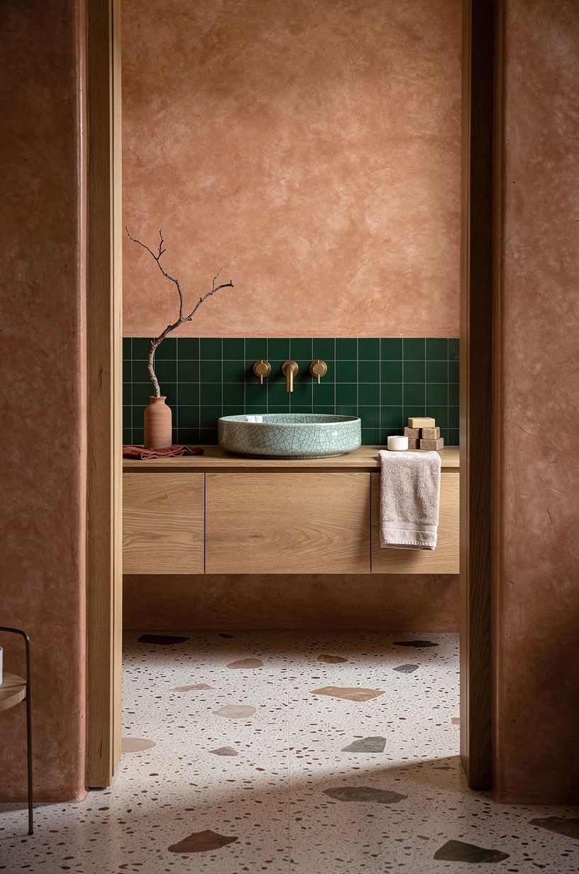 Pair brass fixtures with clay colored walls