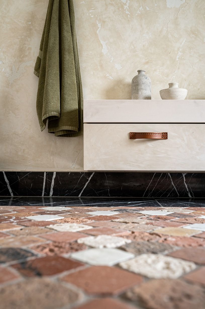 Layer ivory plaster with zellige floor tile (The Quiet Contrast Formula)