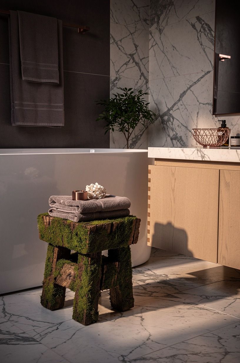 Stage a mossy stool vignette near towels