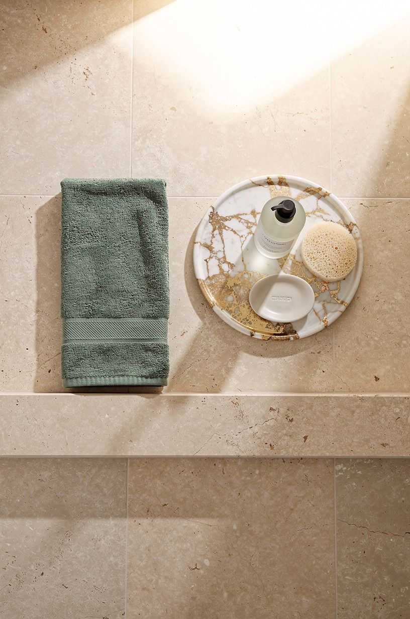Repeat limestone on the shower curb
