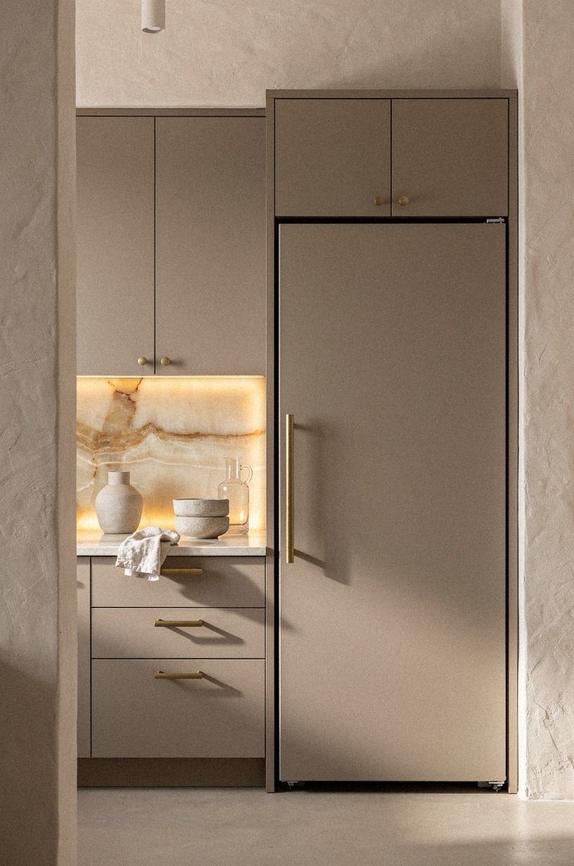 Wrap the fridge in matching cabinet panels