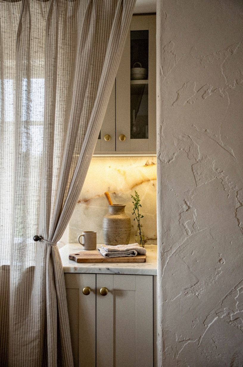 Gather striped linen behind open cabinet frames