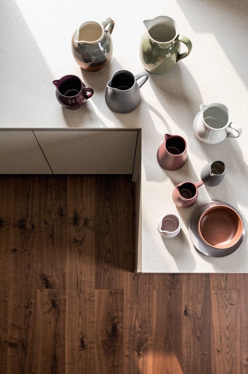 Cluster ceramic pitchers in staggered heights