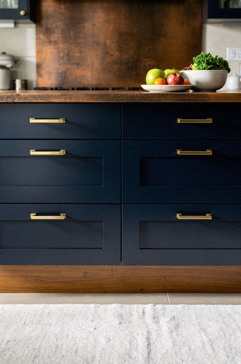 Contrast navy painted bases with brass pulls