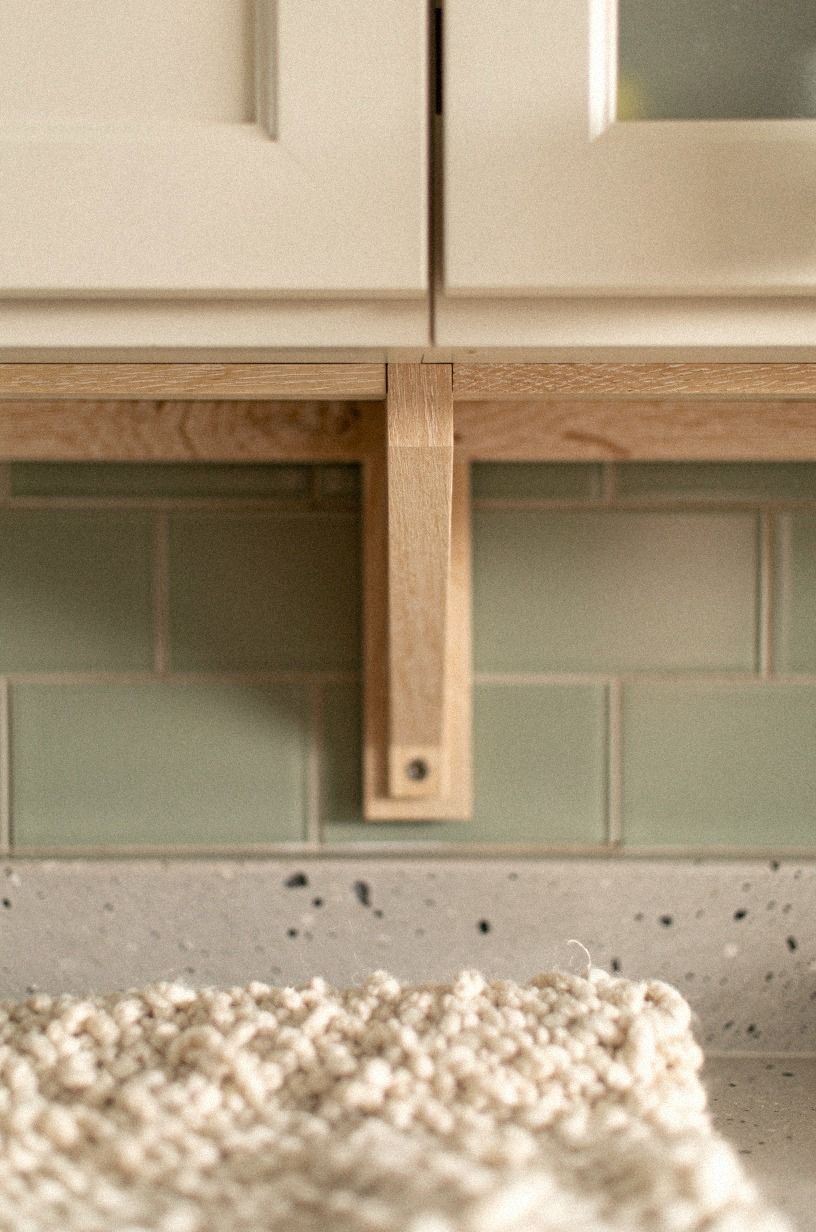 Hang two open shelves between upper cabinets