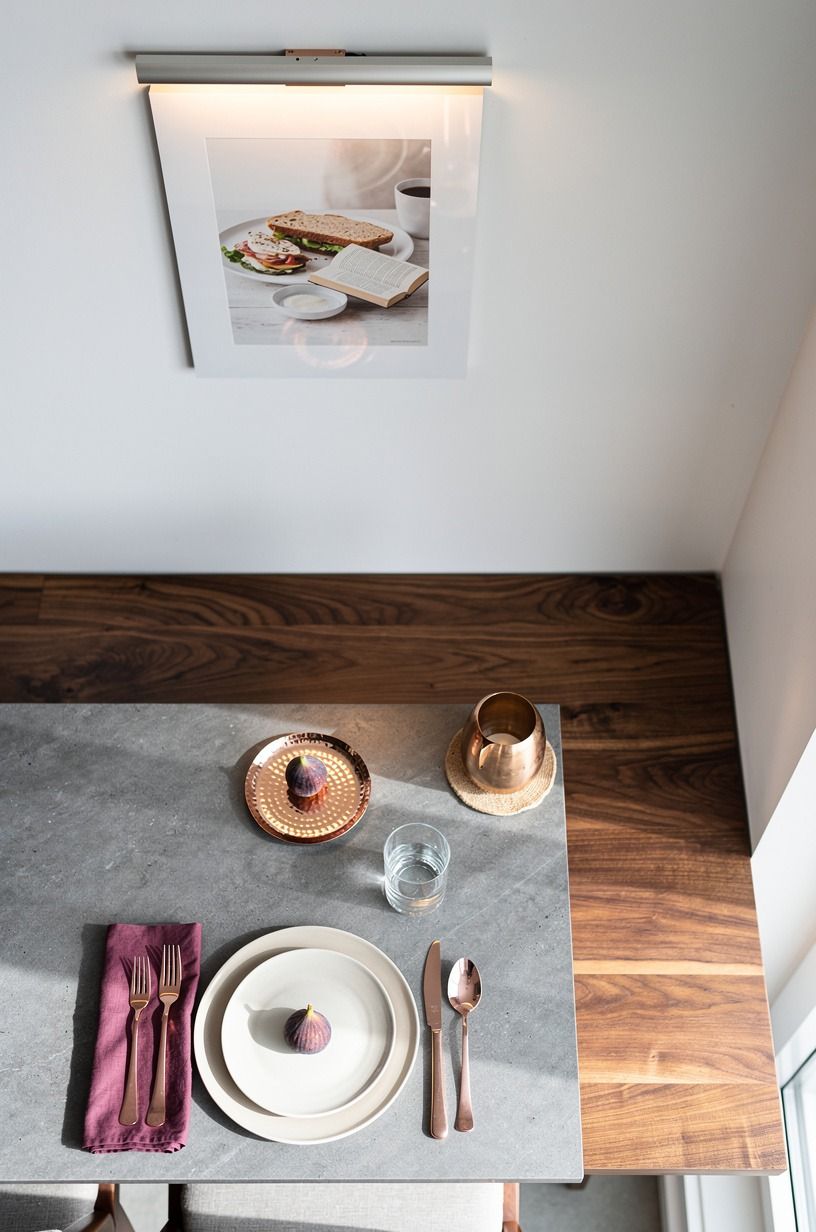Tuck a picture light above breakfast art