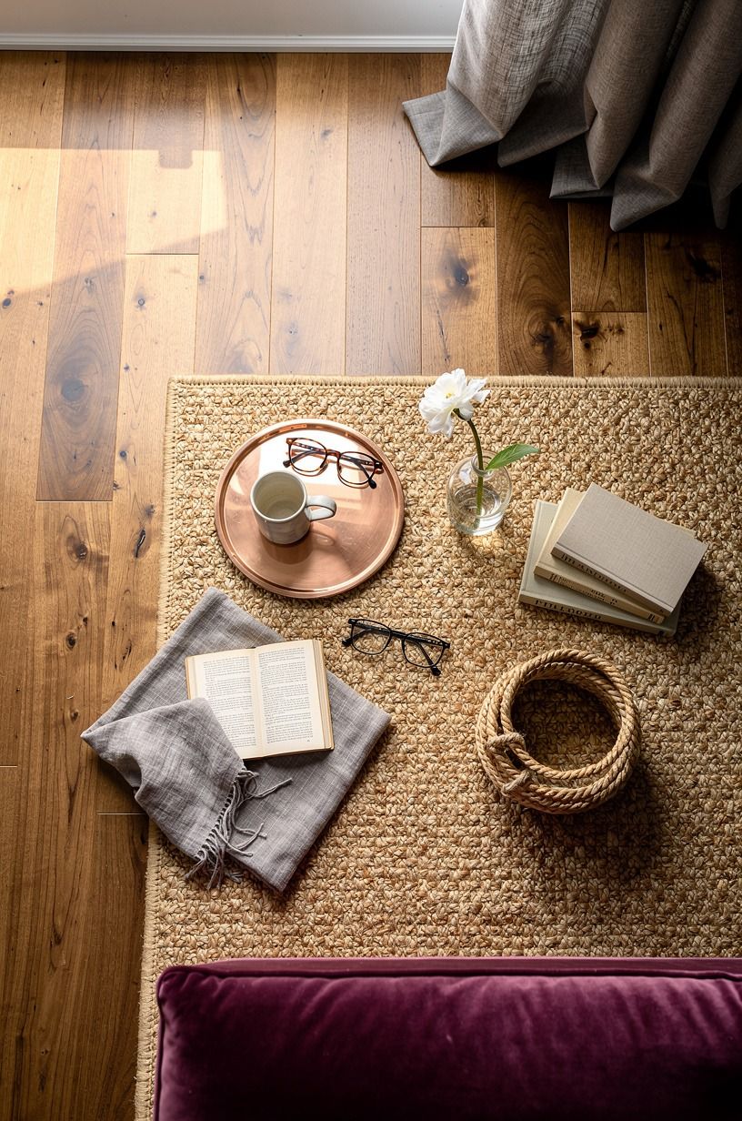 Layer two natural rugs over wide-plank floors