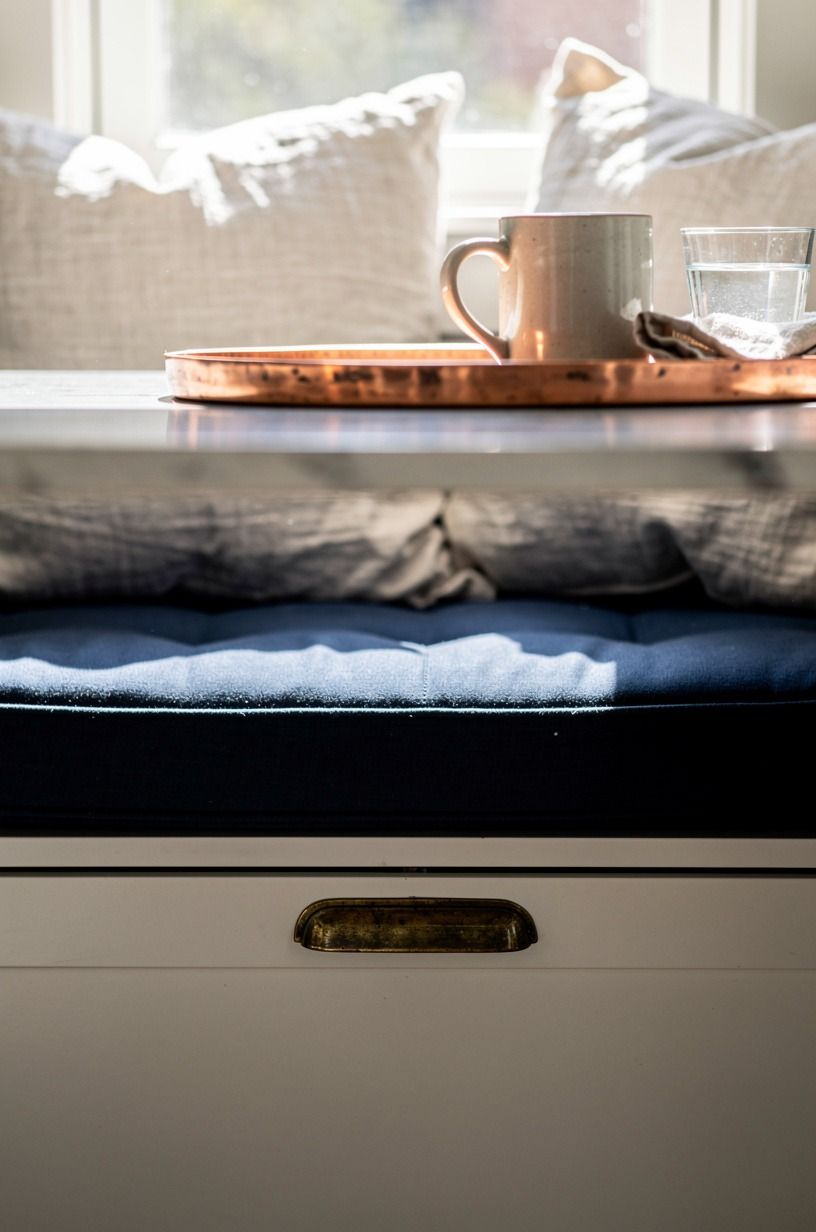 Layer pillows over hidden seat storage