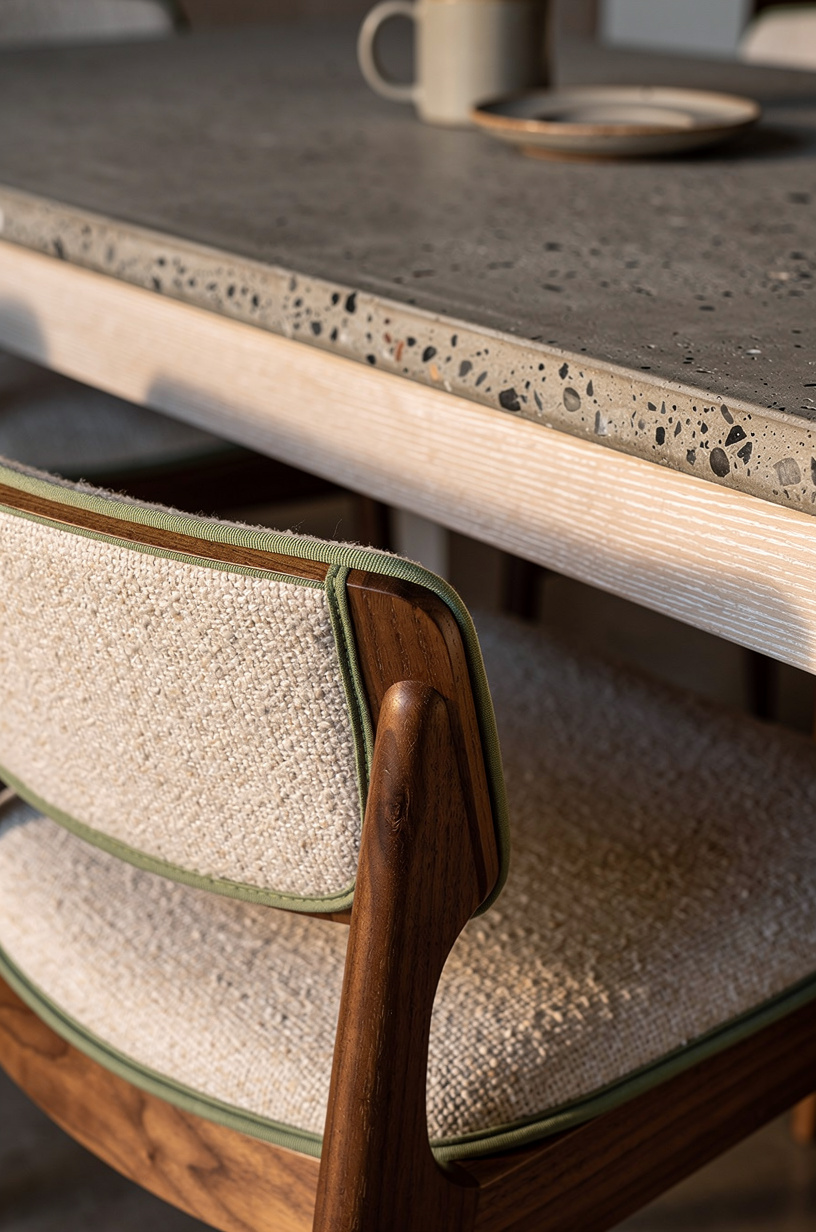Mix boucle cushions with walnut dining chairs