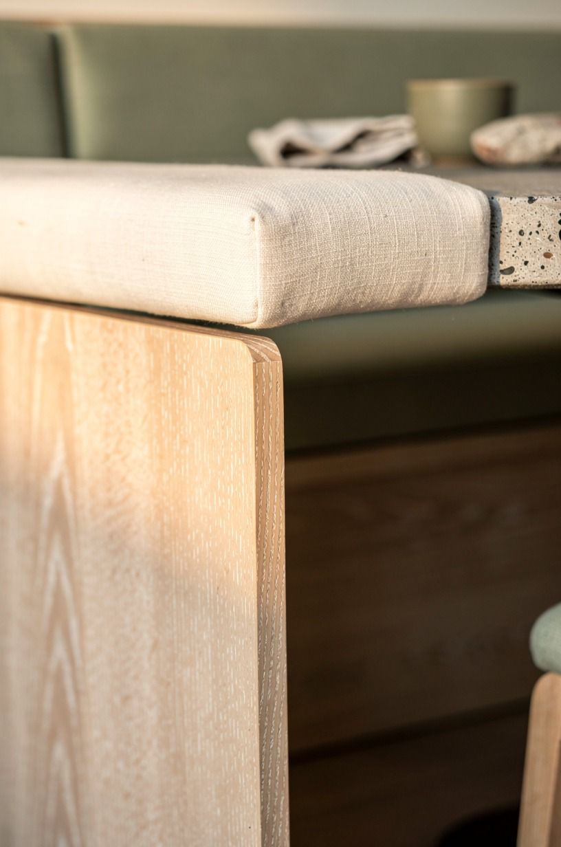 I wrapped the banquette base in warm oak