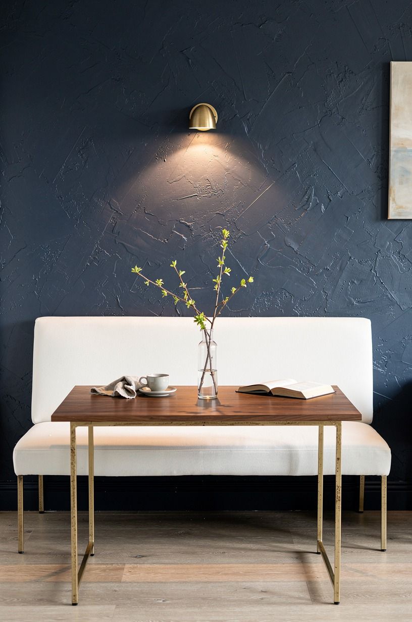 Place a slim settee against the wall