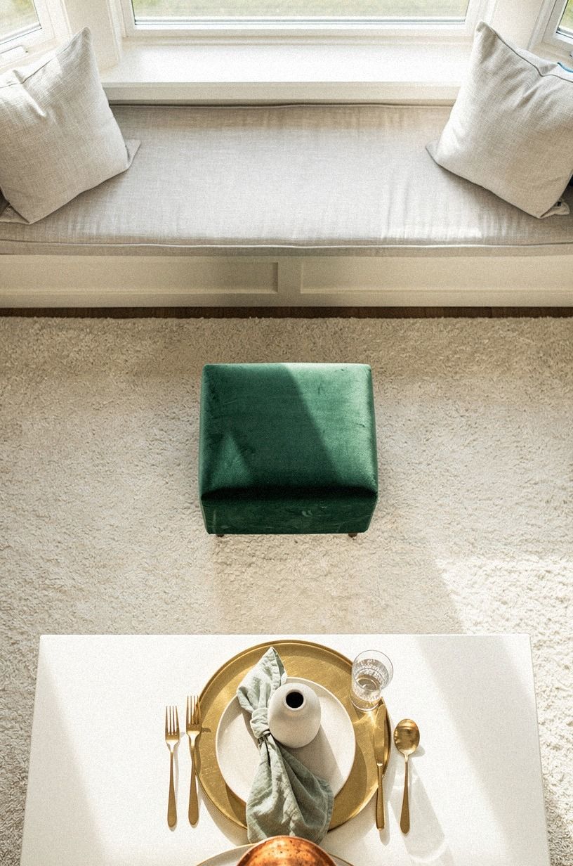 Float a small ottoman near the nook