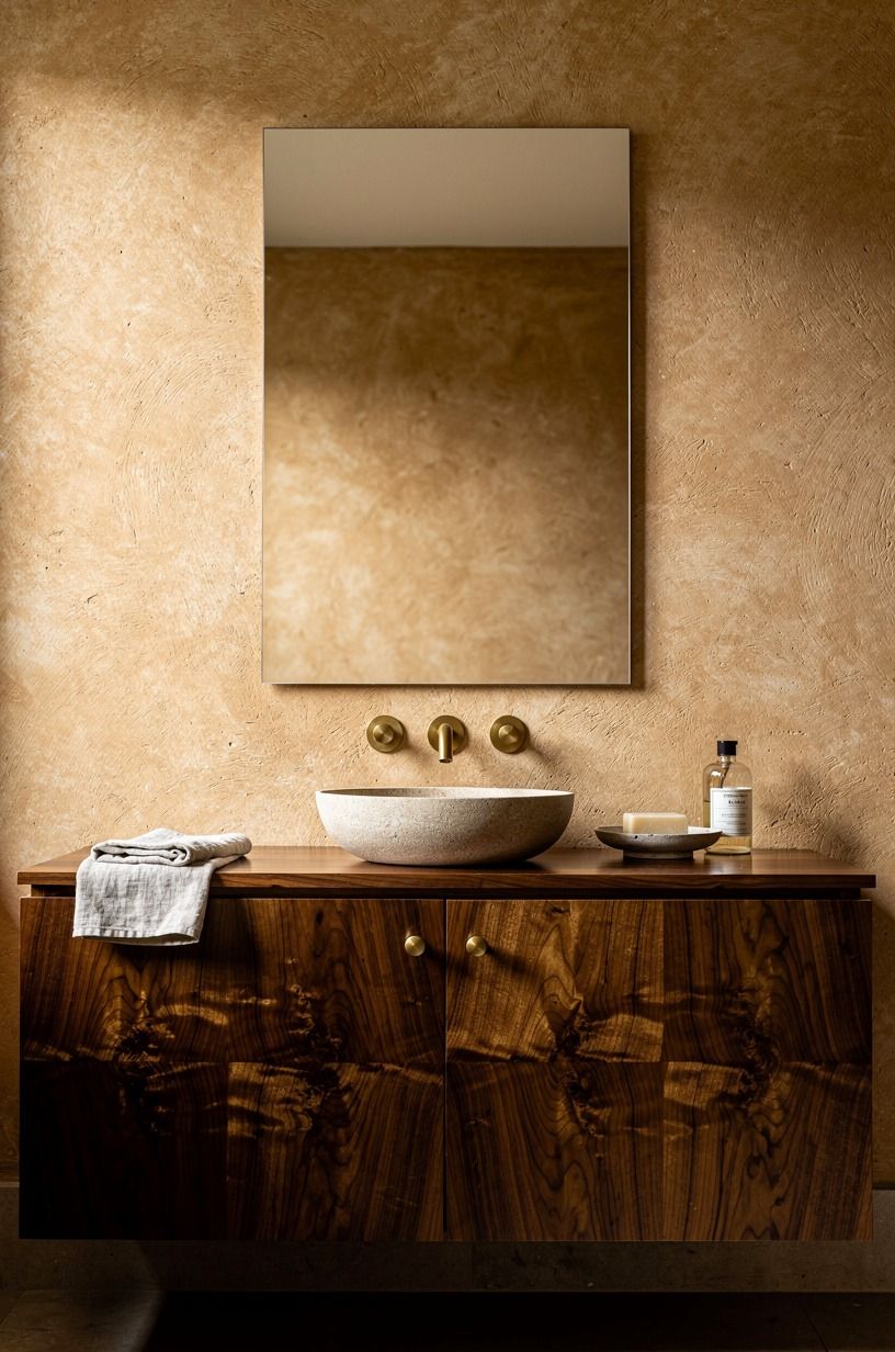 Float the mirror above a warm plaster wall