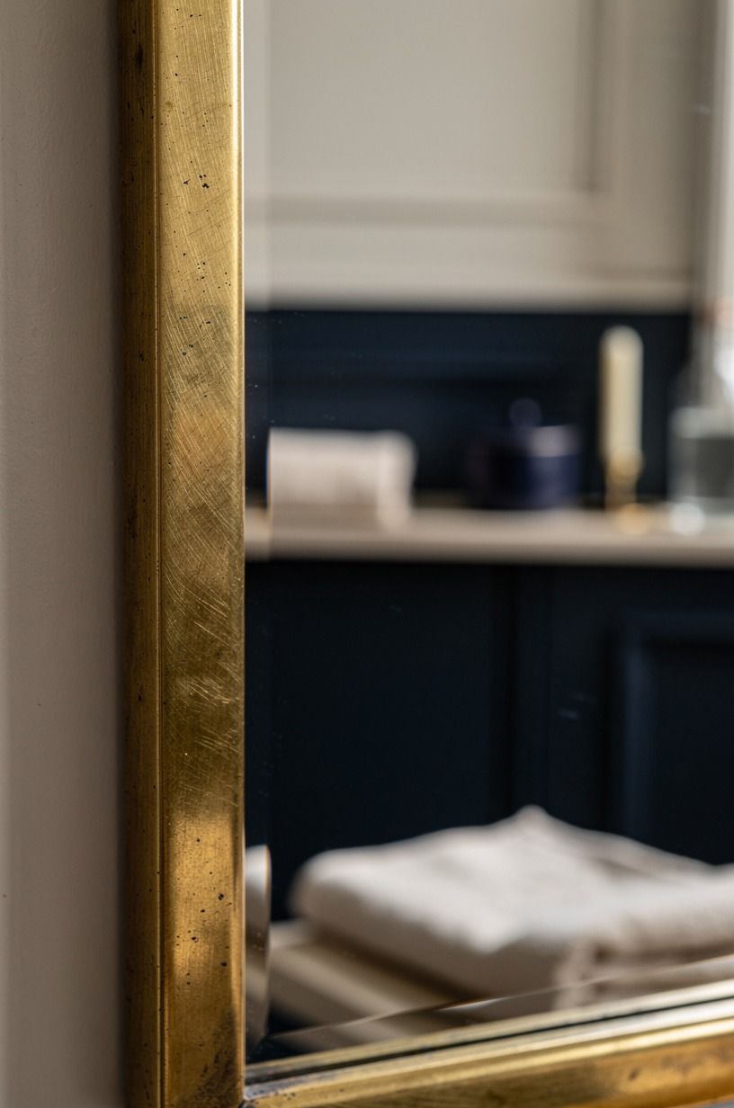 Frame the mirror with a quiet metal finish