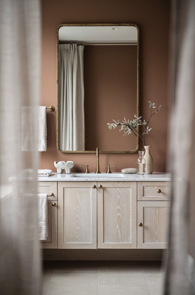 Frame the mirror with unlacquered brass