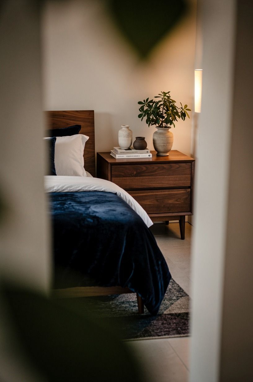 I used warm light to make the healthy bedroom feel finished, navy palette