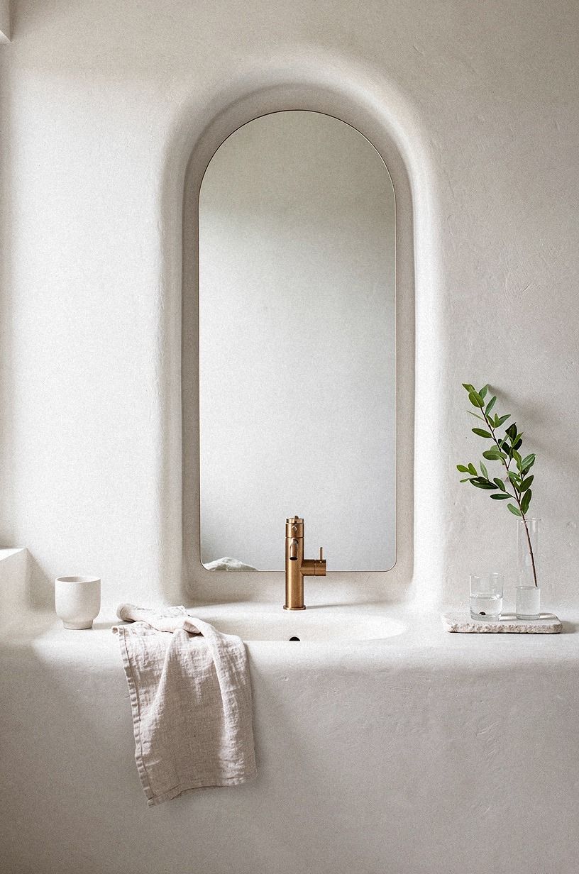 Frame the mirror with a slim plaster reveal